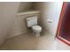 A bathroom featuring a toilet, angled ceiling, floral wallpaper, and a shower at 1427 San Felipe Dr, Boulder City, NV 89005