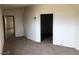 Bedroom with neutral carpeting, vaulted ceiling, and view into another room at 1427 San Felipe Dr, Boulder City, NV 89005