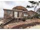 Unique dome-shaped house with stone accents and a sloped, rock-covered front yard at 1427 San Felipe Dr, Boulder City, NV 89005