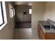 Galley kitchen with stainless steel sink and view into adjacent living space at 1427 San Felipe Dr, Boulder City, NV 89005
