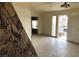 Open living area with tile flooring, stone accent wall, and access to outdoor space at 1427 San Felipe Dr, Boulder City, NV 89005