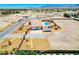 Aerial view of the sprawling property featuring a home, pool, landscaping and large lot with desert views at 1440 Lost Creek Dr, Pahrump, NV 89048