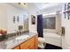 Bright bathroom featuring granite counters, tub and shower combo with a large decorative backsplash at 1440 Lost Creek Dr, Pahrump, NV 89048
