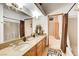 Bathroom with double sink vanity and framed mirrors and decorative vases, plus a glimpse into the next room at 1440 Lost Creek Dr, Pahrump, NV 89048
