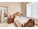 Cozy bedroom with wooden frame bed, side table, and a large sunny window at 1440 Lost Creek Dr, Pahrump, NV 89048