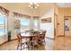 Dining area with a wood table, natural light and views of the outdoor pool at 1440 Lost Creek Dr, Pahrump, NV 89048
