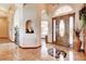 Elegant foyer with decorative tile inlay, arched doorways and a statement front door at 1440 Lost Creek Dr, Pahrump, NV 89048