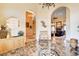Grand foyer with marble floors, decorative lighting and multiple entryways to living spaces at 1440 Lost Creek Dr, Pahrump, NV 89048