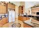 Spacious kitchen with tile floors, wood cabinets, stainless appliances and black countertops at 1440 Lost Creek Dr, Pahrump, NV 89048