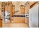 Traditional eat-in kitchen with tile floor, natural wood cabinets, stainless double oven and black countertops at 1440 Lost Creek Dr, Pahrump, NV 89048