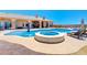 Backyard pool and spa combo surrounded by a patio with lounge chairs for relaxing in the sun at 1440 Lost Creek Dr, Pahrump, NV 89048