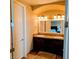 Bathroom with double sinks, granite countertop and dark wood cabinets at 16 Via Visione # 102, Henderson, NV 89011