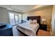 Elegant bedroom with a tufted headboard and private balcony access at 16 Via Visione # 102, Henderson, NV 89011