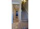 Hallway with marble floors and neutral walls leads to stairs and a dark-colored door at the end of the hall at 16 Via Visione # 102, Henderson, NV 89011