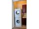 Functional laundry room with stacked washer and dryer at 16 Via Visione # 102, Henderson, NV 89011