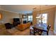 Living room features a stone fireplace, comfortable seating, and sliding glass door leading to the backyard at 16 Via Visione # 102, Henderson, NV 89011