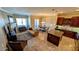 Open-concept living room featuring a fireplace, kitchen island, and dining area at 16 Via Visione # 102, Henderson, NV 89011
