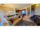 Open floor plan showing the living room and kitchen with an island, stainless steel appliances, and staircase at 16 Via Visione # 102, Henderson, NV 89011