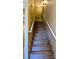 Carpeted stairs with a white handrail leading to the upper floor at 16 Via Visione # 102, Henderson, NV 89011