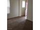 Bright bedroom features neutral walls, carpet, and a doorway leading to another room at 167 Desert Pond Ave, Henderson, NV 89002