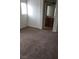 Bedroom with neutral carpet, white walls, and an open doorway to an en-suite bathroom at 167 Desert Pond Ave, Henderson, NV 89002