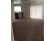 Open-concept living room with carpeted floors and sliding door at 167 Desert Pond Ave, Henderson, NV 89002
