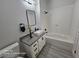 Bright bathroom featuring white cabinets, modern fixtures, neutral countertop, and a combined shower and tub at 1830 N Buffalo Dr # 1091, Las Vegas, NV 89128