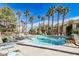 Community pool with lounge chairs and palm trees offering a resort-like atmosphere at 1830 N Buffalo Dr # 1091, Las Vegas, NV 89128