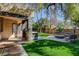 Serene backyard with an outdoor grill, lush lawn, and a cozy fire pit, perfect for relaxation at 1859 Woodhaven Dr, Henderson, NV 89074