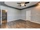 Large bedroom with wood flooring, white trim and an attached staircase with stone wall at 1859 Woodhaven Dr, Henderson, NV 89074