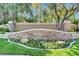 Beautiful stone community sign surrounded by lush landscaping and greenery at 1859 Woodhaven Dr, Henderson, NV 89074