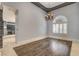 Elegant dining room featuring hardwood floors, designer chandelier, and natural light, perfect for Gathering gatherings and entertaining guests at 1859 Woodhaven Dr, Henderson, NV 89074