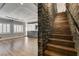 This hallway features hardwood floors, and a view of the living room featuring a stone bar at 1859 Woodhaven Dr, Henderson, NV 89074