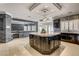 Gourmet kitchen features a central island, stone accents, custom cabinetry, and modern appliances for a chef-inspired experience at 1859 Woodhaven Dr, Henderson, NV 89074