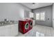 Well-lit laundry room with modern appliances, tiled flooring and a sink at 1859 Woodhaven Dr, Henderson, NV 89074