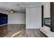 Open-concept living room with fireplace, hardwood floors, recessed lighting, and blue accent wall at 1859 Woodhaven Dr, Henderson, NV 89074