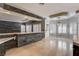 A bright living room features a tiled floor, stone accent bar with marble countertop and a set of white plantation shutters at 1859 Woodhaven Dr, Henderson, NV 89074