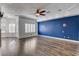 Open-concept living room with hardwood floors, recessed lighting, ceiling fan, and blue accent wall at 1859 Woodhaven Dr, Henderson, NV 89074