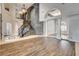 Spacious living area showcasing a grand staircase, stone accent wall, elegant columns, and hardwood floors, creating a luxurious ambiance at 1859 Woodhaven Dr, Henderson, NV 89074