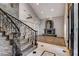 Elegant living room with vaulted ceilings, stone fireplace, wood floors, and grand staircase access for a luxurious feel at 1859 Woodhaven Dr, Henderson, NV 89074