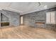 Spacious living room featuring hardwood floors, custom stone accent wall, and an electric fireplace feature at 1859 Woodhaven Dr, Henderson, NV 89074