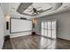 This media room features hardwood floors, a projection screen, and a set of white plantation shutters at 1859 Woodhaven Dr, Henderson, NV 89074