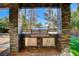 Outdoor built-in grill with stone accents and stainless steel features, perfect for entertaining at 1859 Woodhaven Dr, Henderson, NV 89074