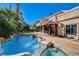 Inviting pool area features lush landscaping, a tranquil waterfall, and a serene spa at 1859 Woodhaven Dr, Henderson, NV 89074