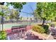 Fenced community tennis court with a bench for resting between sets at 1859 Woodhaven Dr, Henderson, NV 89074