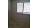 Bright bedroom with tiled floor, enhanced by natural light streaming through the window with wood shutters at 1936 St Lawrence Dr, Las Vegas, NV 89108