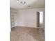 Bedroom featuring tile flooring, closet shelving, and an open doorway at 1936 St Lawrence Dr, Las Vegas, NV 89108