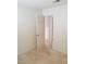Minimalist bedroom with tiled floor, white walls and open door to another room at 1936 St Lawrence Dr, Las Vegas, NV 89108