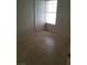 Bright bedroom with tile flooring, a window letting in natural light, and a white door for access at 1936 St Lawrence Dr, Las Vegas, NV 89108