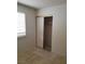 Cozy bedroom featuring a tile floor, window with shutters, and a closet with sliding doors at 1936 St Lawrence Dr, Las Vegas, NV 89108